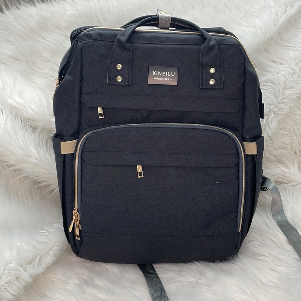 Diaper bag with bassinet